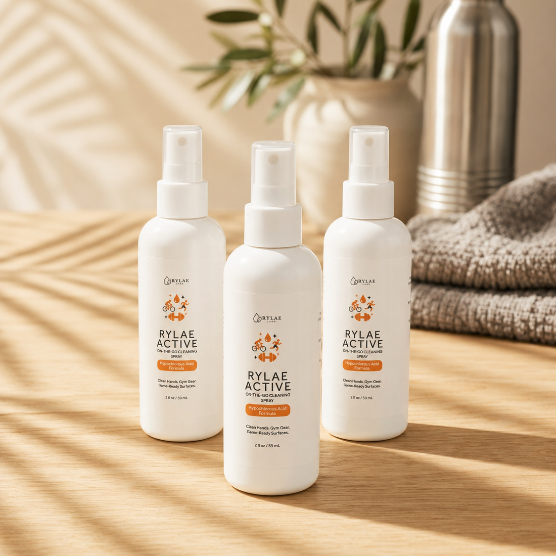 Three Rylae Active 2oz HOCl cleaning spray bottles on white background